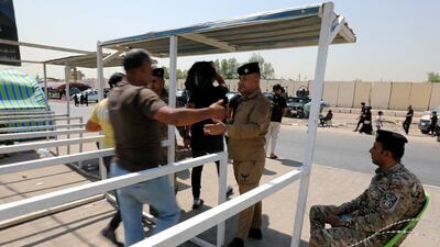 Iraqi policemen check Shiite pilgrims as they make their way to the tomb of Imam Hussain in Baghdad. EPA
