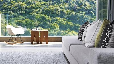 To create the illusion of higher ceilings, they shortened the height of custom-made furnishings – such as the large, L-shaped sofa in the living room – by a fraction