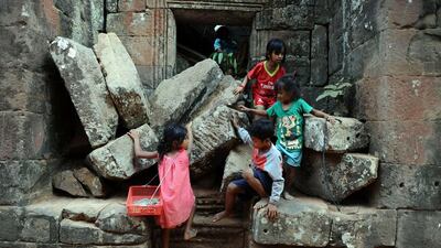Children playing over stones fallen from the surrounding wall of a temple, part of the Angkor architectural complex in north-western Cambodia. Cambodia's Angkor Wat has been digitally mapped for the first time, allowing people to visit the famed temples from the comfort of their armchair using Google Street View. Christophe Archambault / AFP Photo