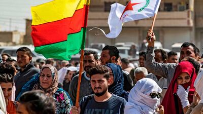 Syrian Kurds wave Kurdish flags. AFP