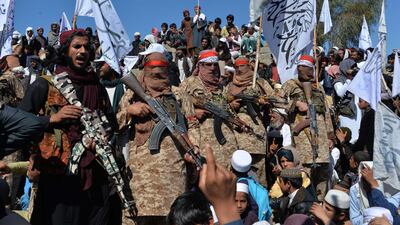 Taliban fighters celebrate with villagers in Alingar district of Laghman Province on March 2, 2020, days after the insurgents signed a deal for a US troop withdrawal from Afghanistan. AFP