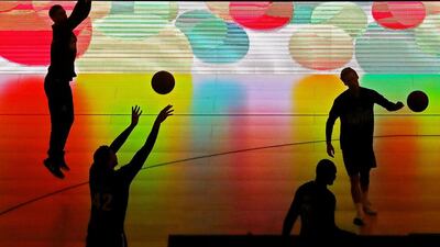 Tai Wesley of Melbourne United and his teammates are silhouetted by an electronic advertising board as they warm up during the round 18 NBL match between Melbourne United and the Illawarra Hawks at Hisense Arena. Scott Barbour / Getty Images