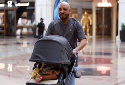 Saeed Saeed and his son explore Mall of the Emirates as part of Dubai Mallathon. Chris Whiteoak / The National