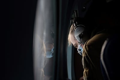 A French navy officer looks through a window on board a Falcon 200 Guardian surveillance aircraft flying above the Yellow Sea between the Korean Peninsula and China to scan the ocean surface for signs of illegal ship-to-ship transfers headed for North Korea. AFP