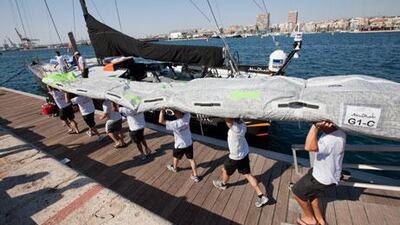 Members of the Abu Dhabi Ocean Racing team carry a mainsail ahead of their training day in Alicante, Spain. The team put together comprises several nationalities, including two Emirati sailors.