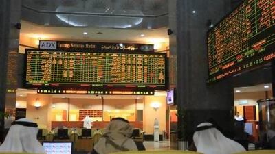 Shareholders watch the boards at the ADX. It seems unlikely to merge with the Emirates' other stock exchanges. Ravindranath K / The National