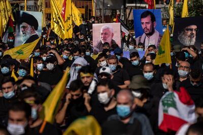 Hezbollah supporters hold up pictures of Iran's supreme leader Ayatollah Ali Khamenei, left, the late commander of Iraq's Popular Mobilisation Forces Abu Mahdi Al Muhandis, second left, Abdel-Malek Al Houthi, the leader of Yemen's Shiite rebels, second right, and Hezbollah leader Hassan Nasrallah. AP