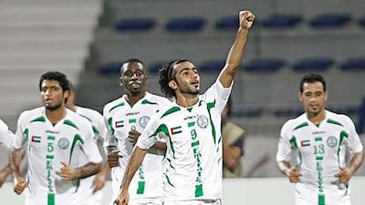 Adnan al Beloshi, centre, celebrates after opening the scoring as Emirate defeated Al Wahda 3-1 to win the Super Cup last night.