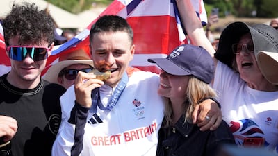 Great Britain's Tom Pidcock is congratulated by his family and partner Bethany Louise Zajac after winning gold. PA