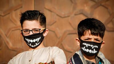 Palestinian children stand outside a mosque upon arriving for the prayers of Eid Al Fitr, in Gaza City. AFP