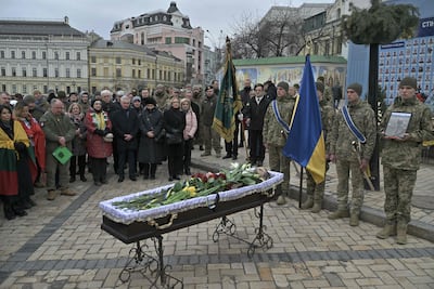 People attend the farewell ceremony in Kyiv on Thursday of Tadas Tumas, a Lithuanian volunteer killed fighting Russian troops in the Donetsk region. AFP