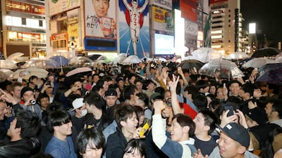 People celebrate as new Emperor Naruhito's era of Reiwa, or "beautiful harmony" began early Wednesda, in Osaka, western Japan. Emperor Akihito announced his abdication at a palace ceremony Tuesday in his final address. AP