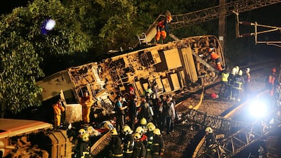 Rescue workers work at the site where a train derailed in Yilan county, Taiwan. REUTERS