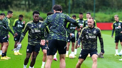 Manchester United's Anthony Elanga and Christian Eriksen during a training session. PA