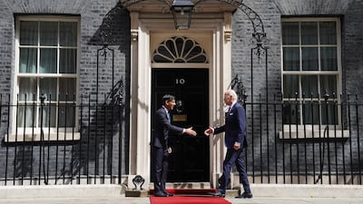Mr Sunak and Mr Biden shake hands outside 10 Downing Street. PA