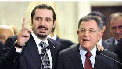 Saad Hariri, left, the caretaker premier of Lebanon, and Fouad Siniora, the head of the Future Bloc Party, speak yesterday in Beirut.