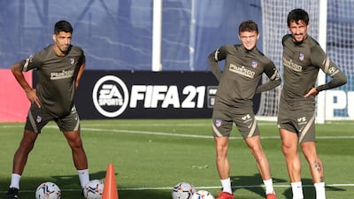 Luis Suarez trains after signing for Atletico Madrid with Kieran Trippier and Stefan Savic. Reuters