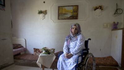 Wounded Palestinian woman Asraah Al Namla , a married woman and mother of two at her parents home in Gaza City on July 3,2015. Azreen lost both of her legs during last summer’s 50 day war between Israel and the Hamas -controlled Gaza Strip Her husband Wael lost his legs, and their son Shareef lost the lower part of his leg . The incident happened on one of the darkest days during the war that has been named ‘Black Friday’ .Palestinians claim 130-150 were killed in the Rafa area of southern Gaza during a breakdown of a cease fire agreement during a tunnel incident between Hamas and Israeli troops .The family was fleeing on foot trying to reach a safer area when an Israeli rocket attack hit them . Wael’s 11 -year old sister and his brother Yusef and his wife were killed . Heidi Levine for The National