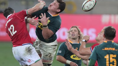 British & Irish Lions' Robbie Henshaw, left and South Africa's Jasper Wiese attempt to catch a loose ball.