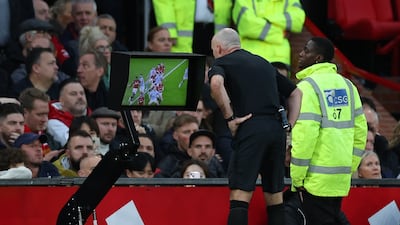 Referee Paul Tierney checks the VAR display before awarding a penalty for Manchester City. EPA