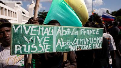 A demonstrator holds a sign reading, 'Long live Mali, long live Russia, down with France, down with Minusma' in Bamako. EPA
