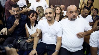 Elor Azaria, flanked by his parents, sits in an Israeli military court in Tel Aviv on July 30, 2017 as he waits to hear the verdict on an appeal against his conviction and 18-month sentence for manslaughter. Dan Balilty / AP Photo