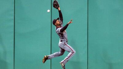 Arizona Diamondbacks center fielder Jarrod Dyson tries to catch a ball during the fifth inning at PNC Park. Reuters