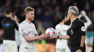 Kevin De Bruyne is handed the match ball by referee Martin Atkinson. Reuters