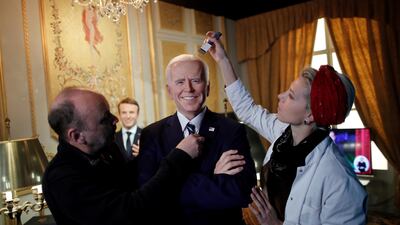 German sculptor Claus Velte and a gallery assistant retouch a waxwork of US President Joe Biden at the Grevin museum in Paris. Reuters