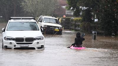 A child kayaks in floodwaters in the town of Yarramalong, north of Sydney, Australia. EPA