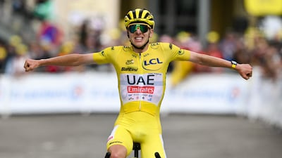 UAE Team Emirates' Slovenian rider Tadej Pogacar, wearing the overall leader's yellow jersey, crosses the finish line to win Stage 14 of the Tour de France from Pau and Saint-Lary-Soulan Pla d'Adet on July 13, 2024. AFP