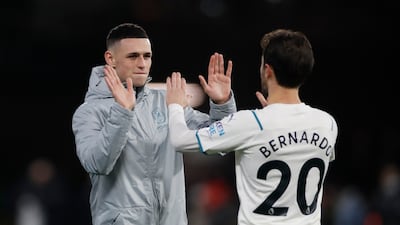 Manchester City's Phil Foden and Bernardo Silva celebrate after the match. Reuters