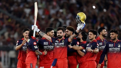 Royal Challengers Bengaluru's Virat Kohli celebrates with teammates after winning the IPL title after defeating Gujarat Titans in the final in Ahmedabad. Reuters