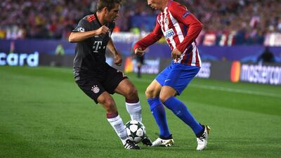 Fernando Torres of Atletico Madrid battles for the ball with Philipp Lahm of Bayern Munich. David Ramos / Getty Images