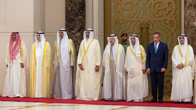 Members of the Kuwaiti delegation stand for the national anthem at Amiri Airport