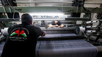 A seamstress operates a loom at the factory. AFP