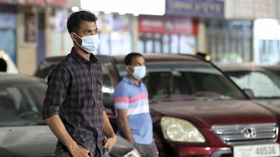 Cricket fans wait outside Sharjah Cricket Stadium during an IPL match.
