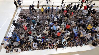 Customers queue outside the Apple store at Dubai Mall. Mahmoud Khaled / EPA