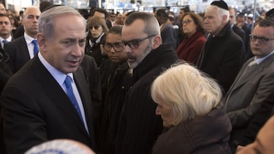 Israeli Prime Minister Benjamin Netanyahu, left, speaks briefly with relatives of Yoav Hattab, one of four French Jews killed in an attack on a kosher grocery store in Paris last week. Photo: Jim Hollander / AP