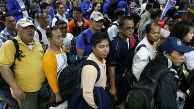 Filipinos who were working at the sprawling oil field in Algeria which was attacked by terrorists arrive at the Ninoy Aquino International Airport in Manila on Sunday. On Monday, the government said six of its citizens had died in the hostage crisis at the gas plant. Bullit Marquez / AP Photo