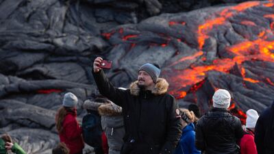 A man takes a selfie in front of the lava field on the Reykjanes Peninsula. Getty Images