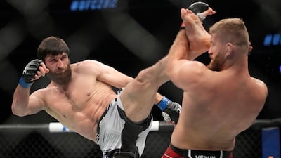 Magomed Ankalaev kicks Jan Blachowicz during their title bout at UFC 282. AP