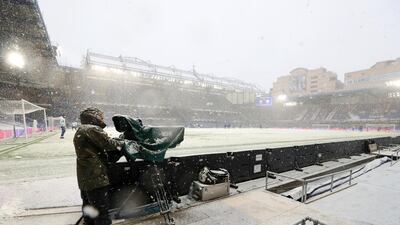 A television camera operator braves the snow ahead the FA Cup fourth-round tie between Chelsea and Luton Town at Stamford Bridge on Sunday, January 24. Getty