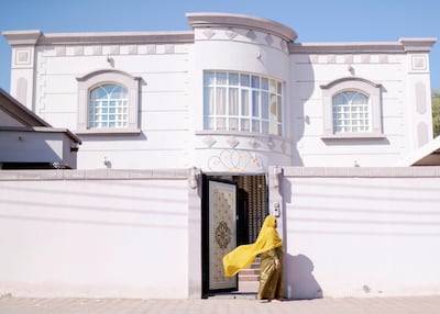 Rahma Abdulrahman Al Buloshi’s grandmother, Mariam Al Shehhi, outside her home in Saham. Reem Mohammed/The NationalSection: NA