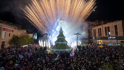 A light show behind the Christmas tree gave Byblos locals a reason to celebrate, despite an uncertain future during Lebanon's economic crisis. EPA