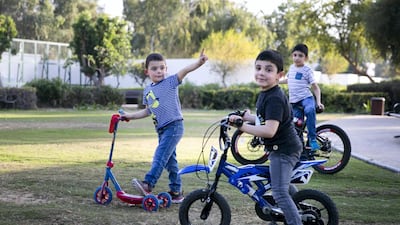 Malik Al Jasser, left, with his brothers, Hayel and Milad in Heritage Park on Abu Dhabi's Corniche.