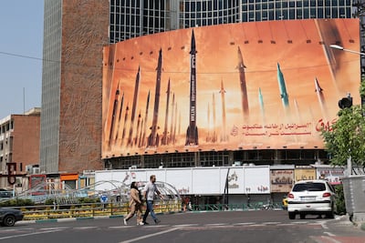 An anti-Israel billboard with a picture of Iranian missiles is seen on a street in Tehran