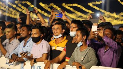 Labourers enjoying the music and dance show.