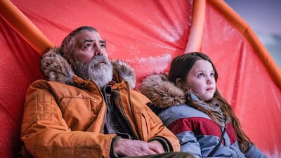 George Clooney and Caoilinn Springall, right, form a touching bond in 'The Midnight Sky'. AP