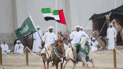 Horse stunts featuring the UAE and Saudi flags at the Sheikh Zayed Heritage Festival. Philip Cheung for the Crown Prince Court – Abu Dhabi